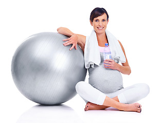 Image showing Pregnant female person, portrait and studio for final trimester, wellness and exercise for motherhood. Maternal woman, workout and white background for health, fitness and ball for towel and water