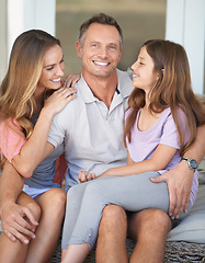 Image showing Dad, girl and mom in portrait on patio with hug, care and love with dad with smile at family home. Father, mother and daughter with embrace, connection or happy to relax together in backyard at house