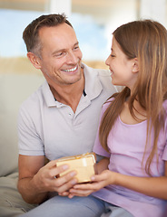 Image showing Smile, father and daughter on sofa with gift box for birthday, achievement and celebration in family home. Giving, happy girl child and dad on couch for present, gratitude and surprise in living room