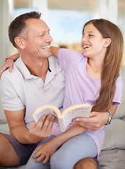 Image showing Father, girl and book on sofa for laughing with hug, care or connection in family home for reading. Dad, child and happy together on couch with teaching, education or embrace for funny story in house