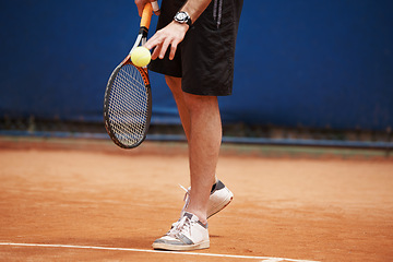 Image showing Man, playing and competition on tennis court, serve and racket or ball for professional match. Fitness, ready or strong athlete in training for tournament, outdoor or skill of champion player in game