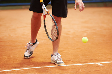 Image showing Athlete, playing and competition on tennis court, serve and racket or ball in professional match. Person, ready and healthy legs in training for tournament, outdoor and skill of strong player in game