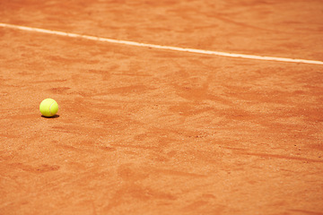 Image showing Tennis ball, clay court and space for fitness, sports or training outdoor in summer with no people. Exercise, health and wellness with mockup on ground of empty stadium or venue for competition