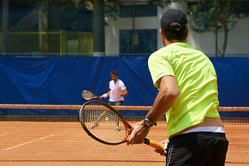 Image showing Fitness, health and tennis with man on court for competition, game or match in summer from back. Coaching, sports or training with athlete person and rival outdoor on clay for workout or hobby