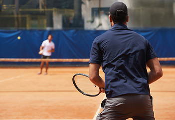 Image showing Fitness, sports and tennis with man on court for competition, game or match in summer from back. Coaching, exercise or training with athlete person and rival outdoor on clay for healthy hobby