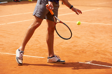 Image showing Tennis, court and legs of person outdoor at start of exercise of workout in competition. Athlete, serving and sneakers of player training with ball on clay pitch in sport, game and action in fitness
