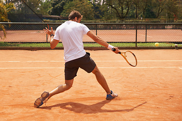 Image showing Man, playing or competition on tennis court, athlete or serve racket or ball for professional match. Fitness, outdoor or person in training for tournament and skill of strong champion player in game