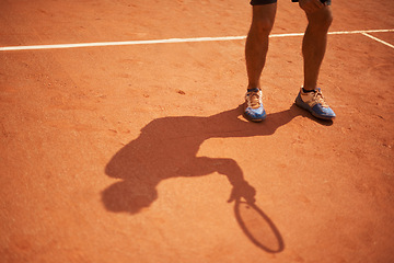 Image showing Tennis, court and shoes of athlete outdoor at start of exercise of workout in competition. Person, shadow and sneakers on feet of player training on clay pitch in game of sport with fitness or action