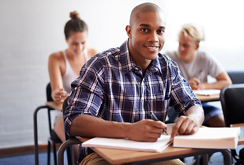 Image showing Black man, portrait and student with book in classroom for studying, reading or writing summary at university. African male person or academic writer with smile for assignment, test or exam at campus