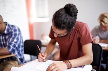 Image showing Man, class and writing in college, learning and knowledge on campus for education. Student, male person and notes for information in book, planning and research for studying or revision for exams