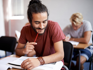 Image showing Man, reading and class with books for thinking, test and solution at university student with education. Person, learning and assessment with ideas, pencil and studying for development in college hall