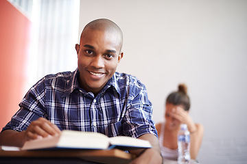 Image showing Classroom, university student and black man with smile, portrait and reading textbook for studying. Male person, happy and learning for information with research for education with scholarship