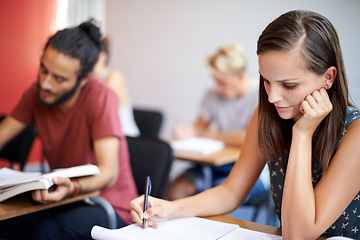 Image showing Woman, writing and class in college, learning and knowledge on campus for education. Student, female person and notes for information in book, planning and research for studying or revision for exams