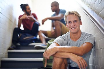 Image showing Portrait, student and man with friends on stairs of college with backpacks, hangout and happiness. Steps, male person and relax with smile in university with people, gen z and scholarship for guy