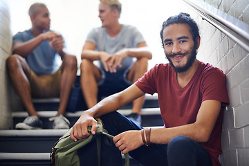 Image showing Portrait, stairs and student with smile, backpack and together with classmates as friends for conversation. University, school and man in course with scholarship, campus and people relax on steps