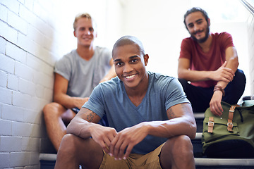 Image showing Portrait, students and happy in university stairs, relaxing and sitting together for break or before class. College people, friends and diversity on campus for education, backpack and casual outfit