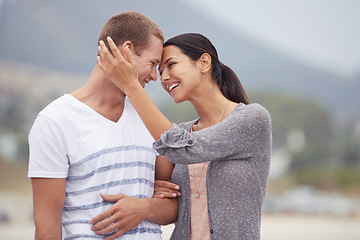 Image showing Happy couple, hug and walk on the beach for travel, forehead touch and together outdoor. Romantic adventure, love and affection for bonding, support and trust with commitment on holiday in Mexico