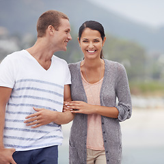 Image showing Couple, hug and walking together on the beach for travel, laughter and happiness outdoor. Romantic adventure, love and comedy for bonding, support and trust with commitment on holiday in Mexico