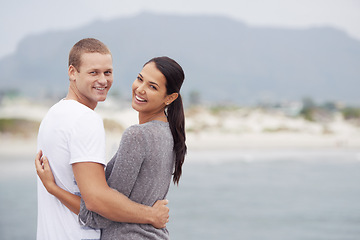 Image showing Couple, beach and happy with hug on holiday for honeymoon, love and relax in New Zealand. Portrait, relationship and ocean for travel on vacation with trip for affection, support and bonding.