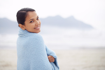 Image showing Woman, towel and beach with portrait, smile and sand for relax and rest in cape town. Tourist, ocean and sea for travel, adventure and holiday with blanket for comfort and positivity in nature