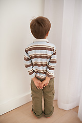 Image showing Child boy, trouble and time out for bad behaviour, discipline and parenting in family home. Punishment, small kid or son in corner of living room, house and childhood development for toddler