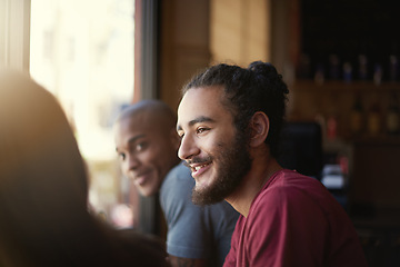 Image showing Face, smile and man with friends in coffee shop together for conversation or bonding on weekend. Customer, relax and summer with group of happy young friends in cafe or restaurant for time off