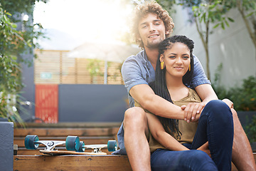 Image showing Diverse couple, outdoor and smile for skateboard, park and date together in summer for boyfriend and girlfriend. Multiracial, male and female for nature, happy and love for outside of city life