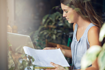 Image showing Student, woman and notebook in cafe for study, knowledge and education with notes, laptop or scholarship. Young person, learning or research in books for assignment, assessment or exam in coffee shop