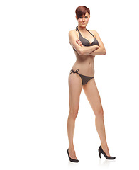 Image showing Portrait, studio and woman with smile for bikini in white background for aesthetic in fashion for model. Female person, confident and carefree for girl in swimwear or underwear, body and happiness