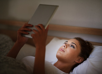 Image showing Woman, tablet and bed at night, social media and entertainment with tech and relaxing for peace before sleep. Female person, browsing and online for home, internet and ebook or scrolling and research