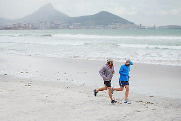 Image showing Men, cardio and running on beach, sand and fitness for wellness and gym wear on coast together. Male athletes, jog and training for seaside, health and outdoor for sport and exercise for freedom