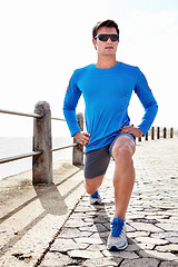 Image showing Man, ocean and stretching for fitness with workout to jog, health and wellness with body care in Chicago. Male person, sportswear and active as runner with sunglasses for exercise, beach or committed