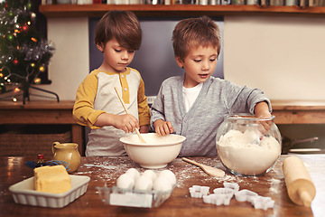 Image showing Kids, baking and playing in kitchen with flour, home and bonding with ingredients for dessert cake. Children, mixing and bowl for cookies on counter, eggs and boys learning of pastry recipe by butter