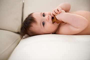 Image showing Baby, cute and happy with dummy on sofa for sleep, healthy development and growth. Infant, adorable and innocent with smile, calm and pacifier on couch to relax in family home with support and love