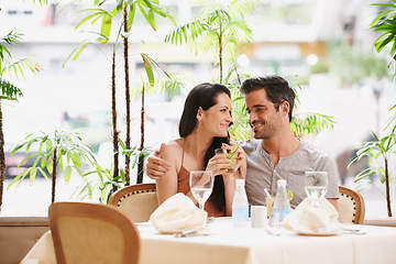 Image showing Couple, restaurant and drinks with lunch, love and romance for anniversary or celebration. Woman, man and date with luxury, fine dining and smile for relationship on holiday or vacation with meal