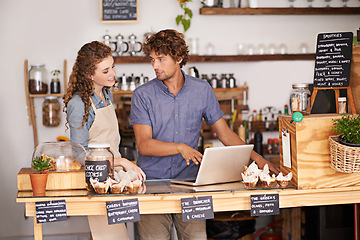 Image showing Computer, bakery and small business people with team for of sales, planning and advice in startup. Young woman and man or water in review for inventory, profit and e commerce on laptop at cafe