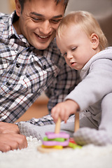 Image showing Happy father, baby and playing with toys in house with love, pride and learning shapes or color in living room. Dad, daughter and educational game for creativity and development of fine motor skills