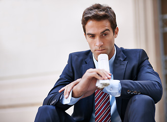 Image showing Businessman, thinking and newspaper for ideas for corporate company in city as employee of business. Man, ambitious and sitting on street and thoughtful about stocks information on finance of work