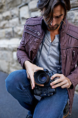 Image showing Man, photographer and change camera lens for work, portfolio and outdoor shoot in London. Photography, creative, artist and freelancer at urban setting to film and street moments for profile.