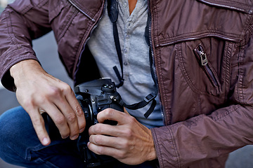 Image showing Hands, man and photographer with camera for creativity, profile and work on content outside in London. Street scene, artist and freelancer in urban to film, shoot and photography for portfolio