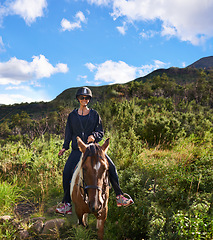 Image showing Riding, horse and portrait of woman on adventure in vacation or holiday journey on path in nature. Training, animal and person travel on trail with pet in countryside, woods and summer with happiness