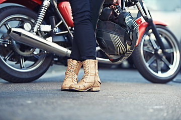 Image showing Legs, road and person with a motorcycle for urban journey and commute in Prague, Europe. Riding, break and people with feet closeup for motorbike commute in the Czech Republic with confidence