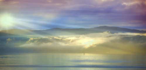 Image showing Ocean, sunset and sand with sunlight on island and tourist destination for summer vacation in nature. Blue sky, clouds or neon color on torrey pines beach, landscape or outdoor travel in california