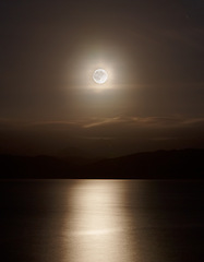 Image showing Ocean, night and full moon on water for natural light, silver and seascape for low tide in nature. Dark sky, moonshine and lunar cycle for animal reproduction or stargazing and gravity pull on earth