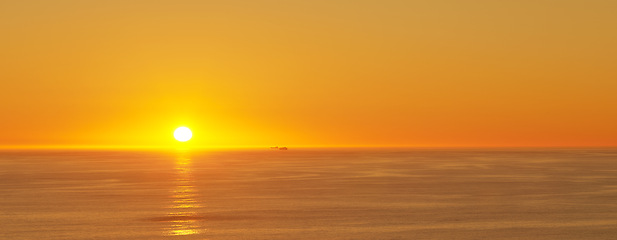 Image showing Ocean, sunset and sun on horizon for landscape and tourism destination for summer vacation in nature. Bright sky, clouds and golden sky on island beach, seascape and sunshine for salutation of day