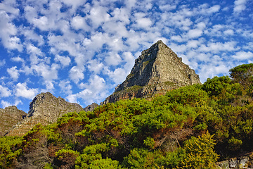 Image showing Mountains, environment and blue sky with nature, summer and stone with landscape and weekend break. Empty, rock and grass with flowers and countryside with spring and travel with holiday or sunshine