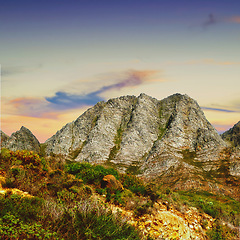 Image showing Mountains, environment and blue sky with nature, rock and stone with landscape and sunset with travel. Empty, rock and grass with flowers and countryside with summer and spring with earth and plants