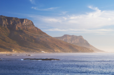 Image showing Mountain, clouds and natural island with sea, blue sky and calm landscape for travel location. Nature, fog and sustainable environment with earth, ocean and holiday destination with tropical summer