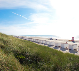 Image showing Travel, drone and beach house freedom in Denmark for luxury, experience or aesthetic cabin accommodation at sea. Aerial view, nature and holiday homes in Jutland with fresh air, ocean view or holiday