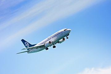 Image showing Airplane, flying and blue sky for travel, holiday and vacation or immigration opportunity with New Zealand airline. Plane, aircraft and transportation in air or outdoors for an international flight